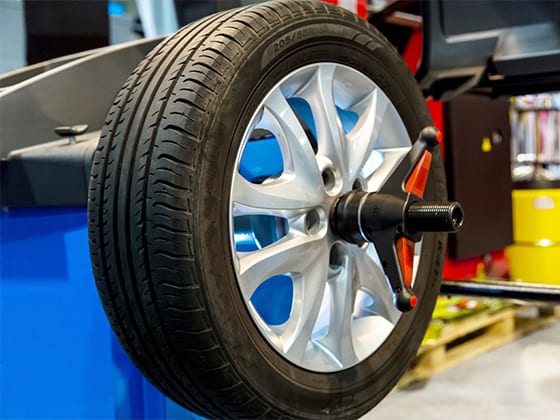 Car wheel on blue wheel balancing device